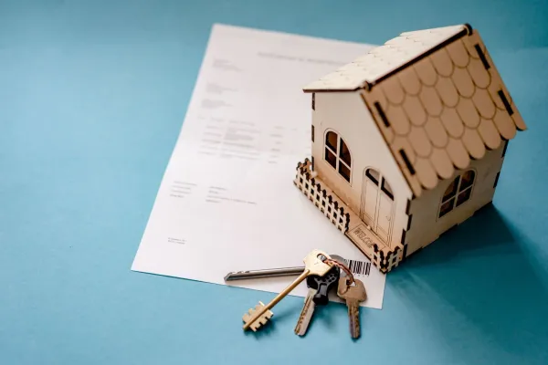 House keys and closing documents on a wooden table representing a Virginia home closing