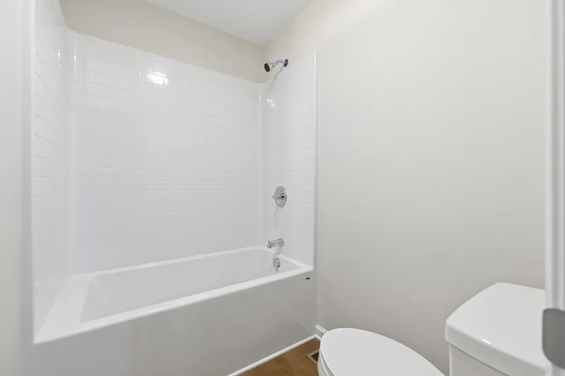 Hall bath with tub and white subway tile