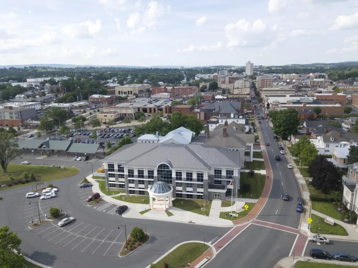 Aerial view of downtown Harrisonburg, Virginia, with the Shenandoah Valley and mountains on the horizon