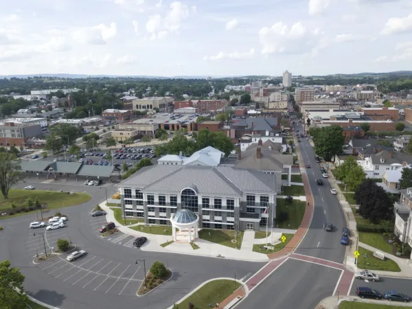 Aerial view of downtown Harrisonburg, Virginia, with the Shenandoah Valley and mountains on the horizon