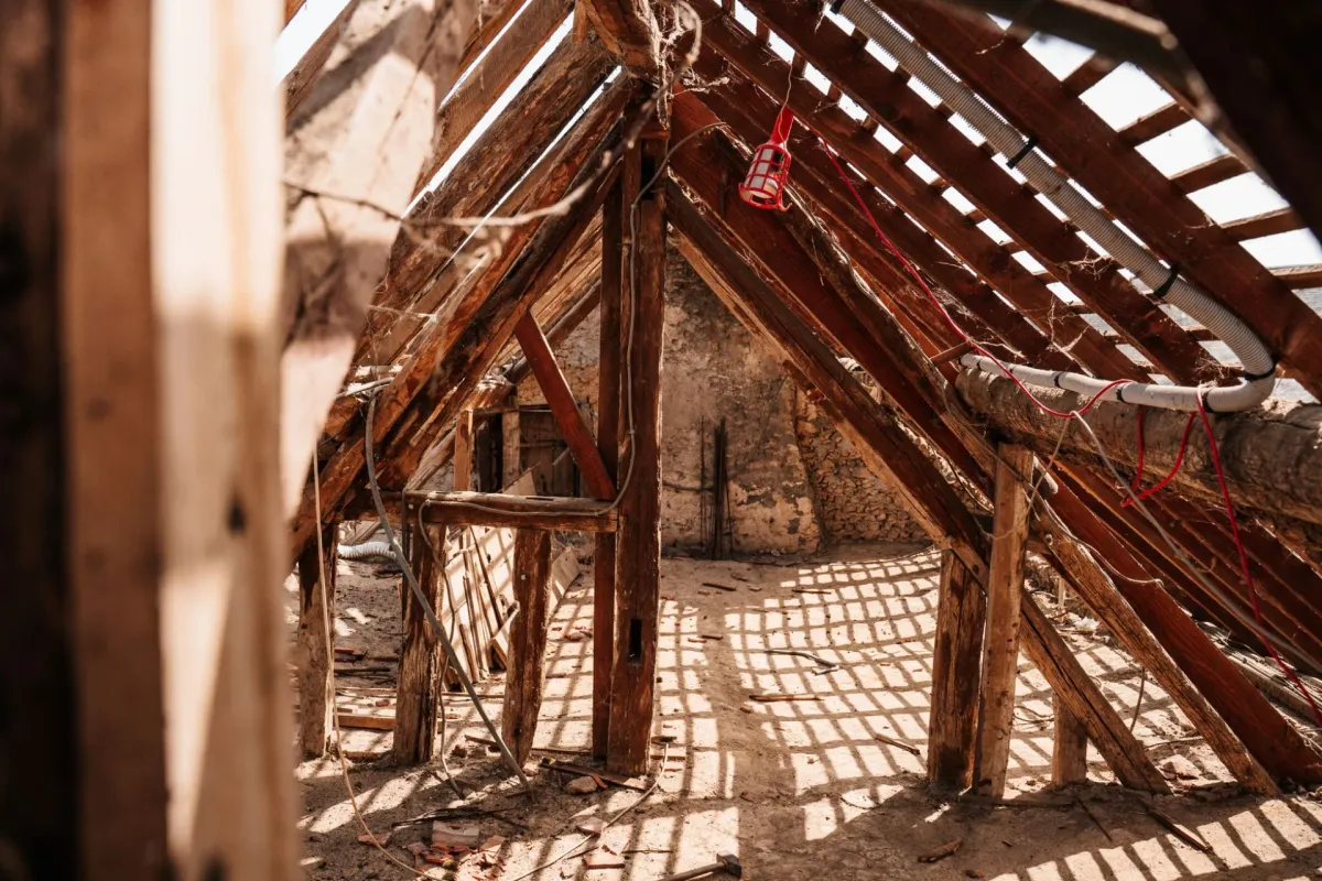 Wooden framing and rafters inside an attic space.