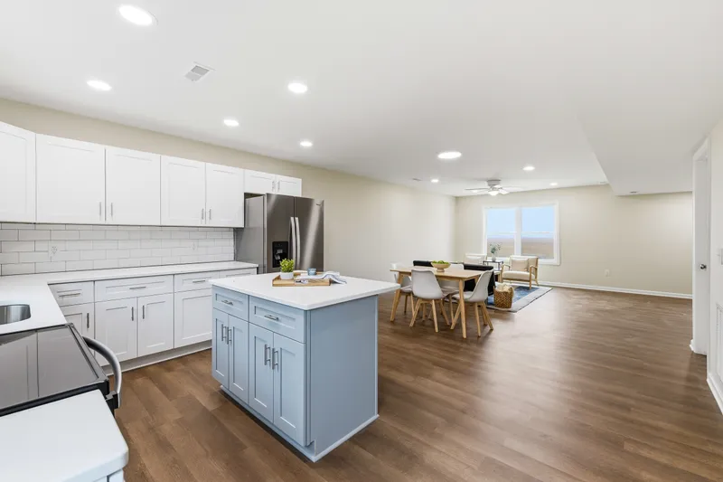 Kitchen with white shaker cabinets, quartz counters, subway tile backsplash, and stainless appliances
