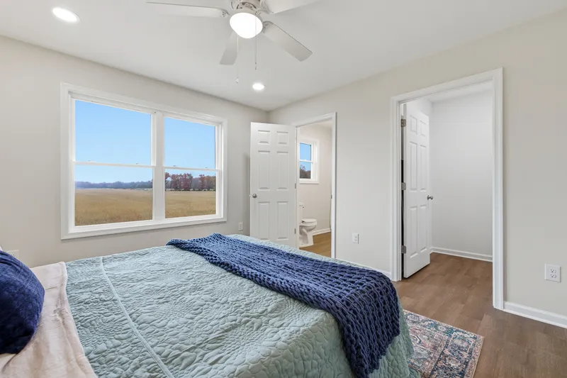 Primary bedroom with large window framing Shenandoah Valley views