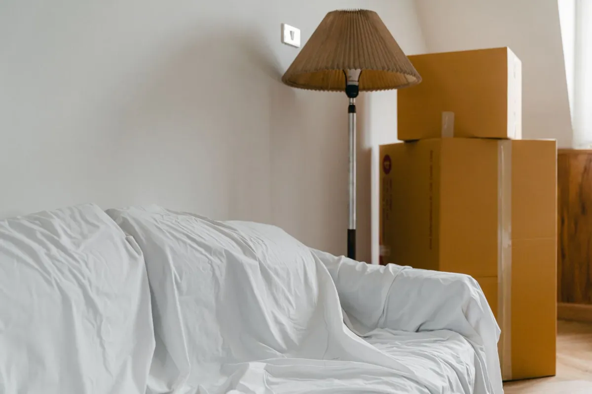 Moving boxes stacked in the front room of a house