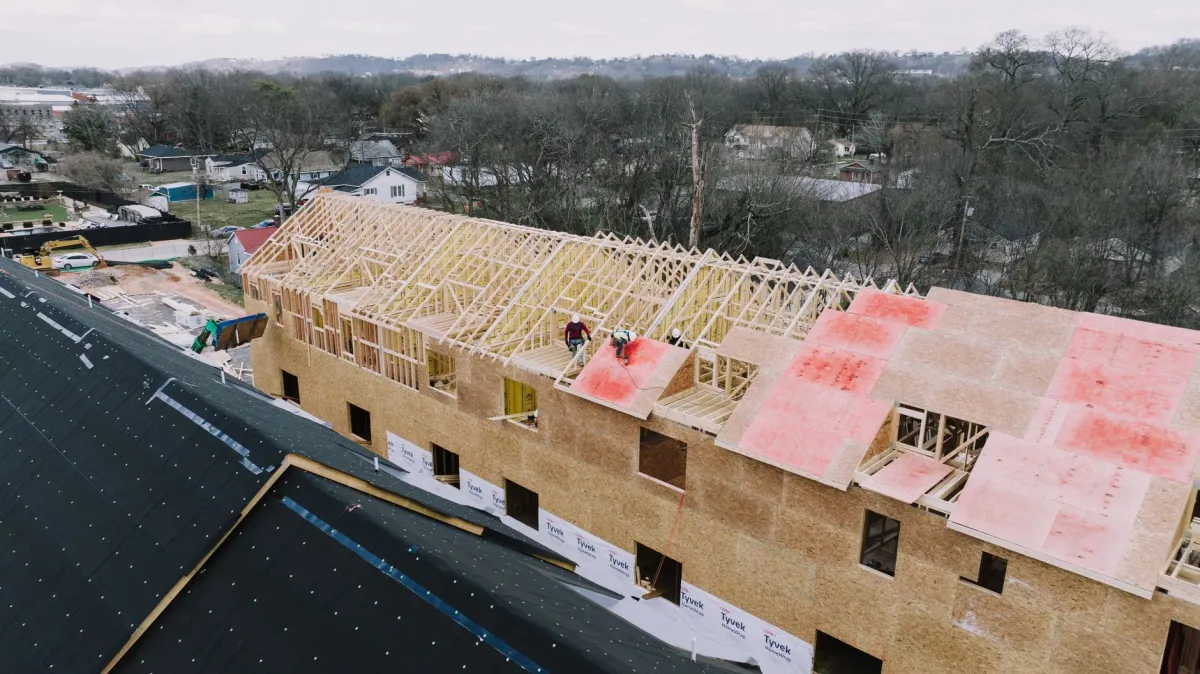 Stock aerial photo of a wood-framed apartment building under construction, not the West Mosby Road project